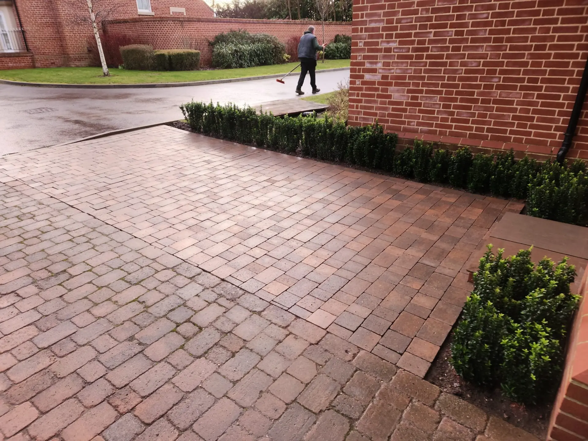 Finished block paved driveway with contrasting border course and clipped box hedging