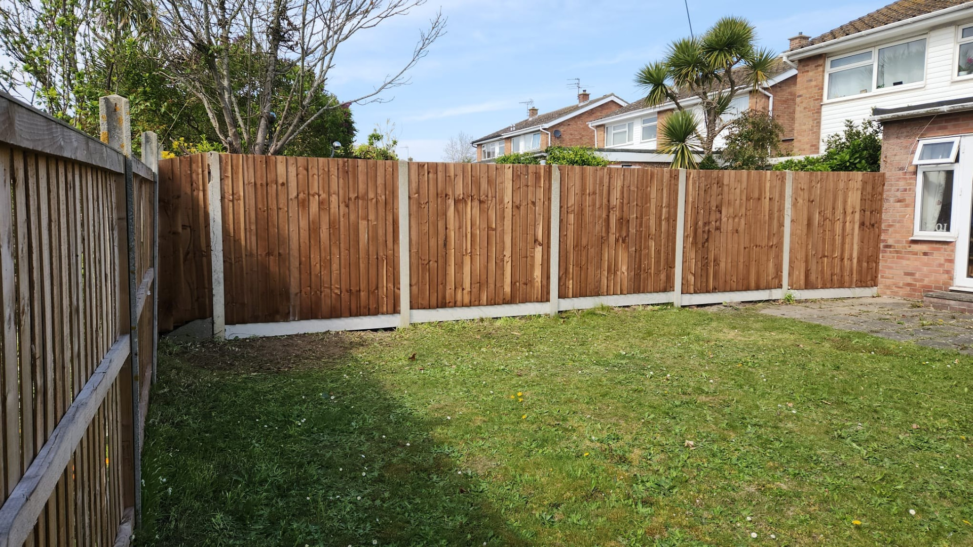 New close-board timber fence panels with concrete posts and gravel boards